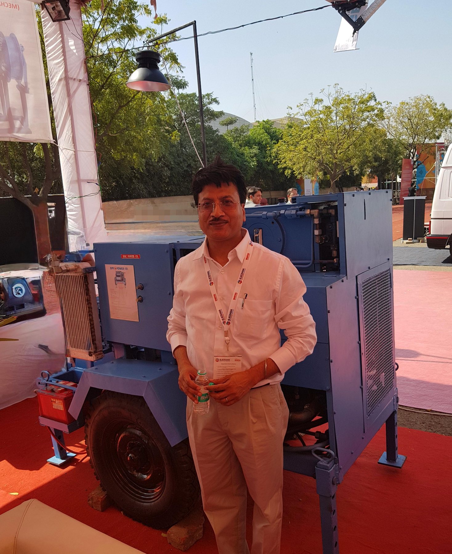 Yougesh Ranjan Gupta beside a BMC Power hydraulic machine at ELECRAMA